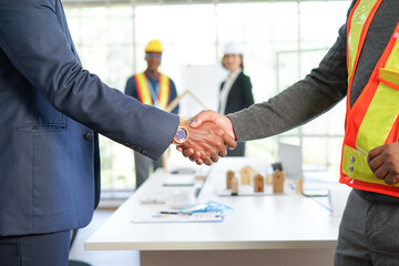 project management engineer and businessman partnership shake hand to joy successful agreement in...