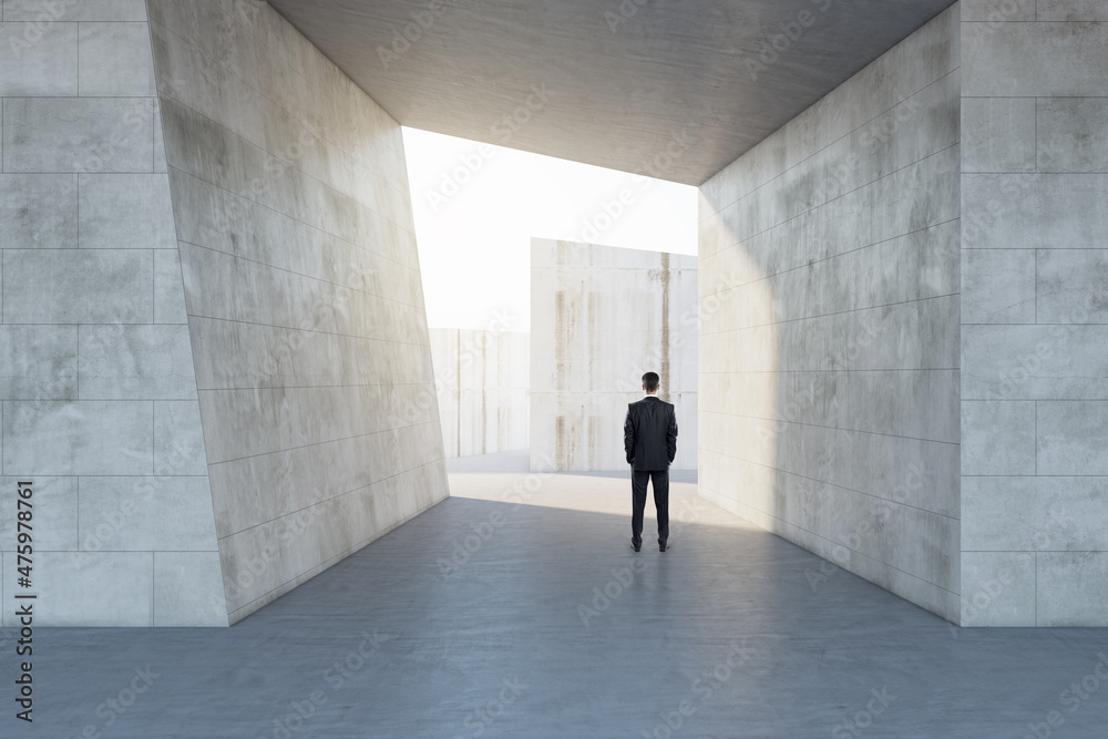Aufkleber businessman standing in abstract concrete tile space interior background with sunlght. design and ab