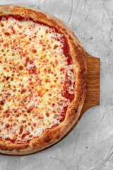Selective focus traditional stone-baked pizza Margarita on stone table