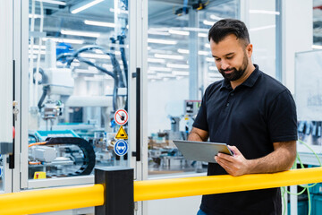 Maintenance engineer using tablet PC at electrical industry