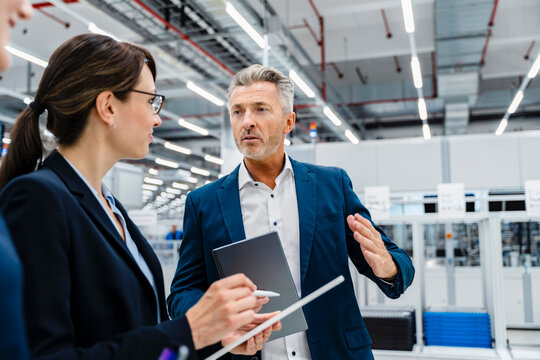 Businessman explaining coworkers in automated industry