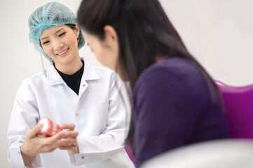 dentist talking with her client in dental clinic