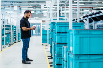 Maintenance engineer using tablet PC at warehouse