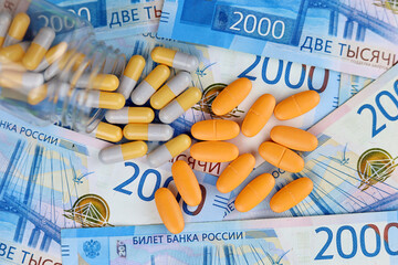 Pills on new banknotes of the russian rubles. Medication in capsules, concept of pharmaceutical...