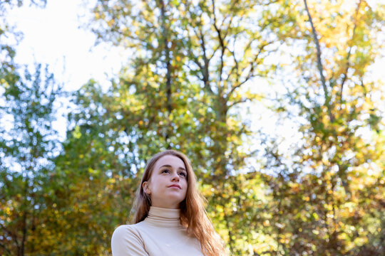 Contemplating young woman in forest