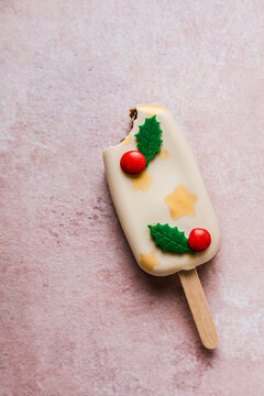 Christmas decorated white cake pop with missing bite