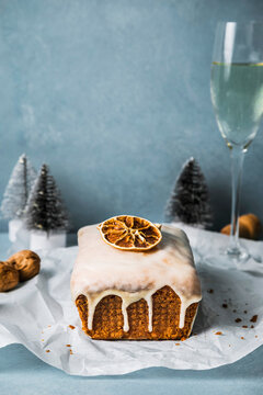 Tempting orange bread cake with wineglass on table