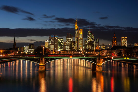 Germany, Hesse, Frankfurt, Ignatz Bubis Bridge at night with illuminated downtown skyline in background