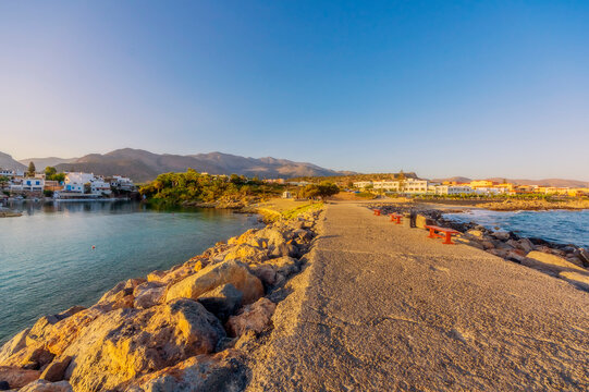 Greece, Crete, Sissi, Road connecting coastal village at dusk