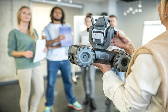 Developer introducing robotic combat tank model to team at workshop