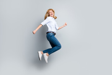 Full size photo of crazy marketer entrepreneur lady jump up enjoy discount wear denim jeans isolated silver color background