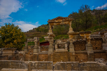Fototapeta na wymiar EPHESUS, TURKEY: On Kuretov Street, the Fountain of Troyan and the ruins of the ancient city of Ephesus.