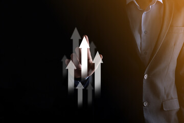 Business man holding holographic graphs and stock market statistics gain profits. Concept of growth planning and business strategy. Display of good economy form digital screen