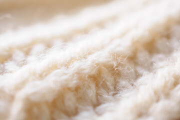 closeup beige knitted woolen fabric texture background