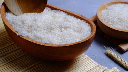 Rice in an oval wooden bowl and some kitchen ornaments neatly and beautifully arranged on a table. food and beverage concept. 