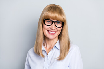 Portrait of attractive cheerful girl hr recruiter executive director wearing specs isolated over...