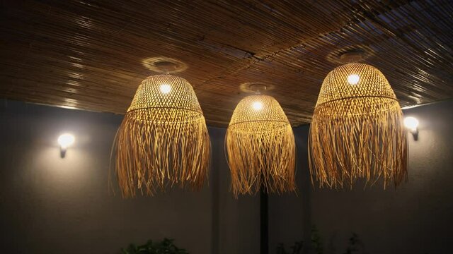 Rustic lighting decor, lamps lit at night. Pan left