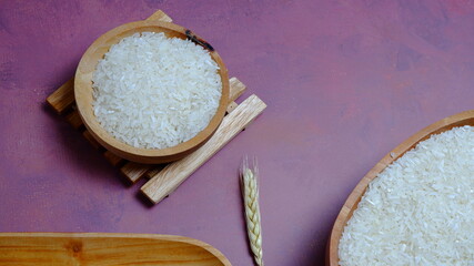 Rice in an oval wooden bowl and some kitchen ornaments neatly and beautifully arranged on a table. food and beverage concept. 