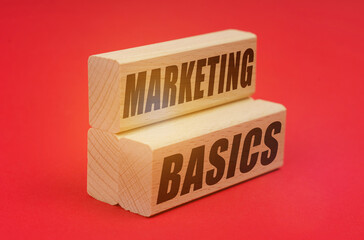On a red background, wooden blocks with the inscription - MARKETING BASICS