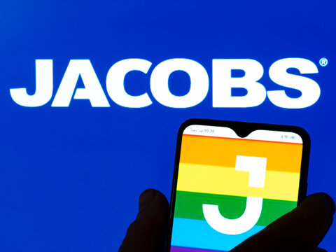 In this photo illustration Jacobs Engineering Group Inc. logo seen displayed on a smartphone in the background.