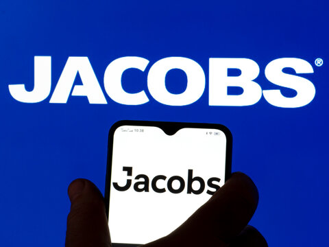 In this photo illustration Jacobs Engineering Group Inc. logo seen displayed on a smartphone in the background.