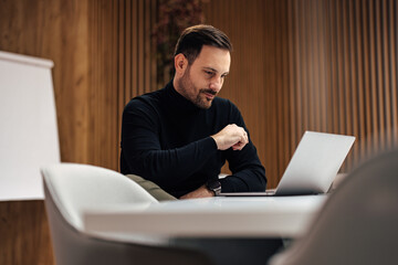 Concentrated adult caucasian man, focusing on his his work in the firm.