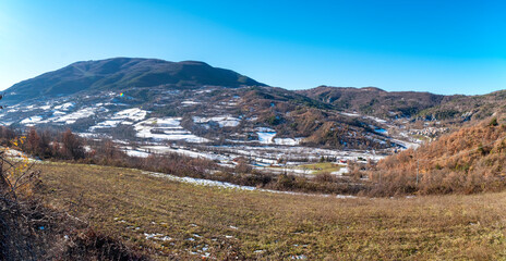 Wide angle winter panorama of the hilly area of Oltrepo Pavese (Northern Italy, Lombardy Region), covered by snow.