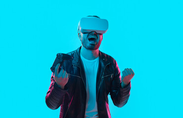 Excited man in VR glasses celebrating win in videogame