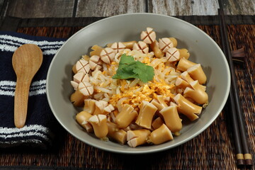 Spicy fried rice noodle topping with pork sausage serving on the plate. Famous street food menu in Asia restaurant. 
