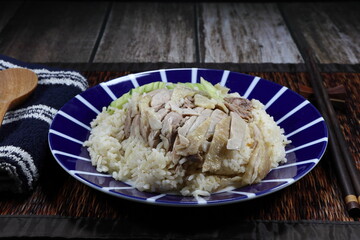 Pile of steamed chicken meat topping on jasmine rice serving on the plate. Famous street food menu in Asia restaurant. 