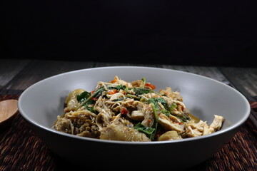 Traditional spicy fried chicken with basil and chilly serving on the plate. Famous hot and spicy menu in Asia restaurant. 
