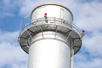 Close-up industrial view photo of metallic chimney tower.