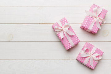 Valentine day composition Background: red gift box with bow and heart. Christmas present. View from above. Holday greeting card