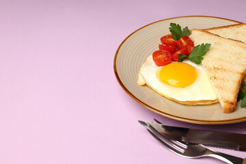 Plate of tasty breakfast on violet background