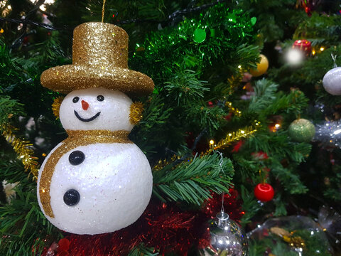 Snowman Doll on branch of Christmas Tree with Colorful Balls decoraion as Christmas or Newyear Festival Concept.