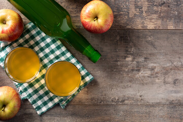 Apple cider drink on rustic wooden table. Top view. Copy space