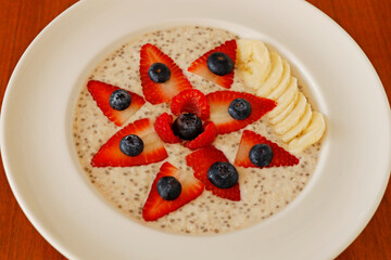 homemade porridge oatmeal cooked in almond milk with berries and banana