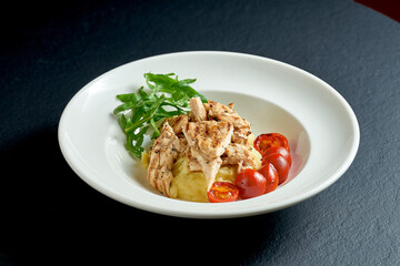 Escalope with mashed potatoes on white plate on black background
