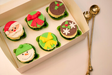 Christmas cupcakes, New Year's dessert. Santa claus cupcakes, snowman cupcakes. Dessert for new year and christmas