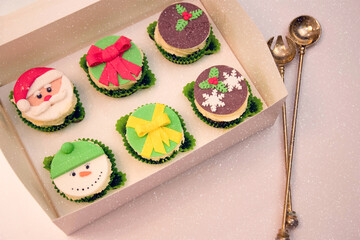 Christmas cupcakes, New Year's dessert. Santa claus cupcakes, snowman cupcakes. Dessert for new year and christmas