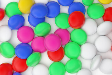 Multi-colored tablets of medicines, scattered on the table.