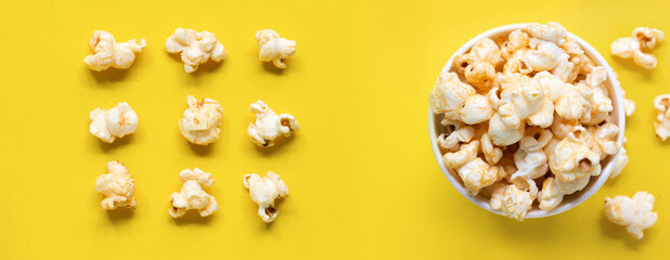 Popcorn viewed top Paper cup with popcorn on white isolated , yellow popcorn