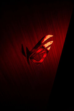 Scenic shot of the logo of ROG Asus, hardware made for gamers, in red color in darkness