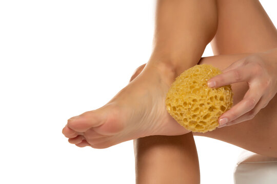 Woman pampring her leg with sponge