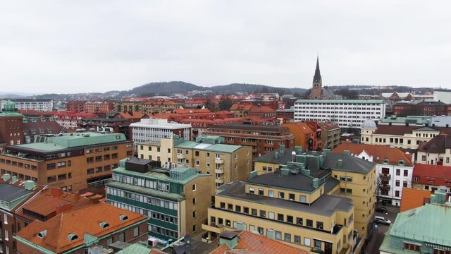 Colorful living apartment buildings and church tower of Bor&aring;s town, aerial fly forward view