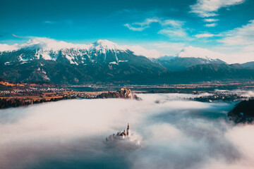 amazing panorama of Lake Bled Blejsko Jezero on a foggy morning with the Pilgrimage Church of the...