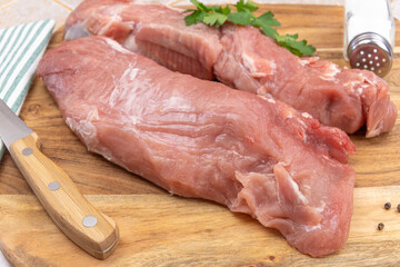 raw pork tenderloin on a cutting board