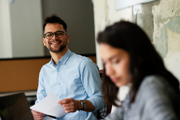 Colleagues in office. Businesswoman and businessman discussing work in office. Two friends working together