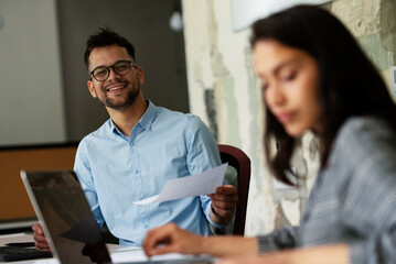 Colleagues in office. Businesswoman and businessman discussing work in office. Two friends working together