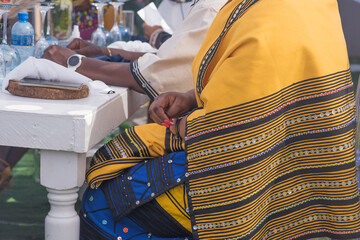 Woman in traditional clothing seen sitting at table